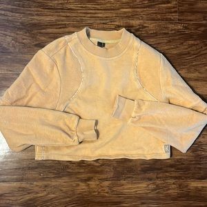 Kith cropped tan sweatshirt with stitching detail.